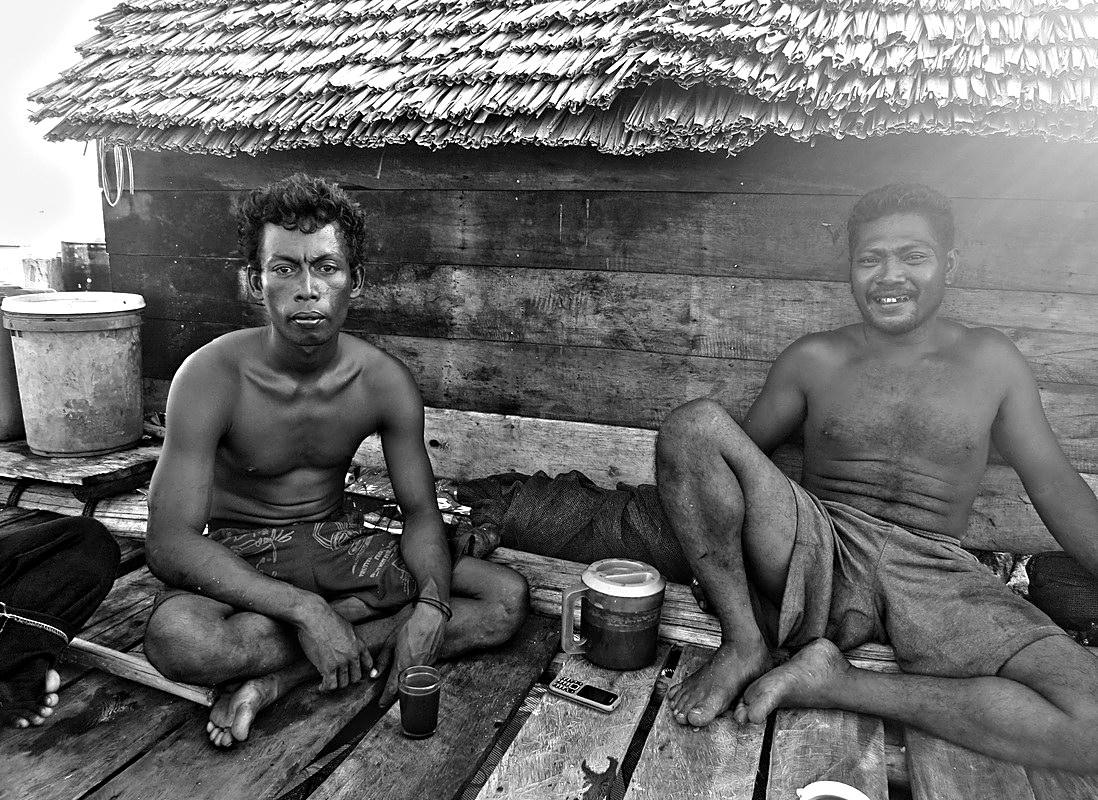 Two fishermen at a stilt hut, Riau Archipelago