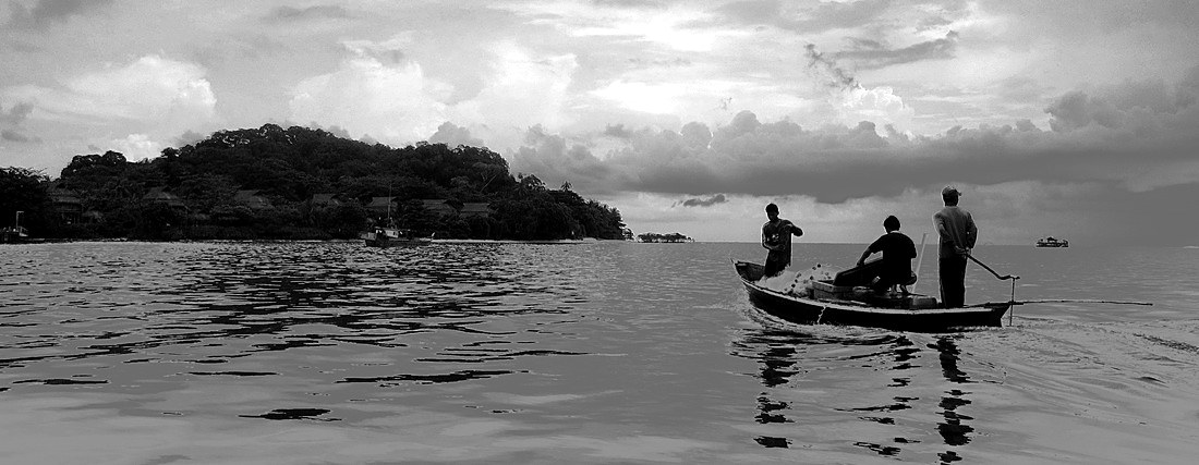 Three fishermen heading out from Kawal at dusk, Riau Archipelago