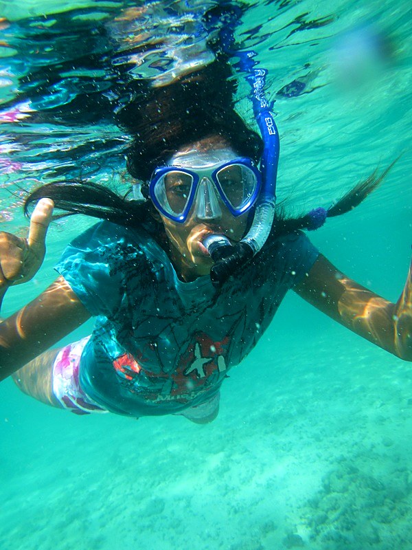 Snorkeling over the reef at Merapas
