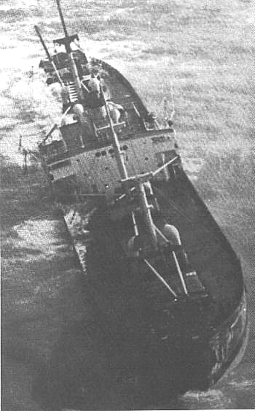 Black and white photograph of a sunken steel fishing trawler off Nikoi